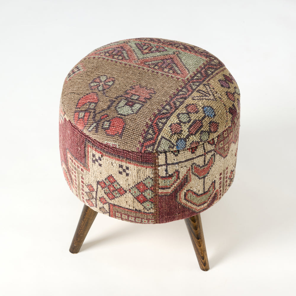Round ottoman with patterned fabric cover on a white background