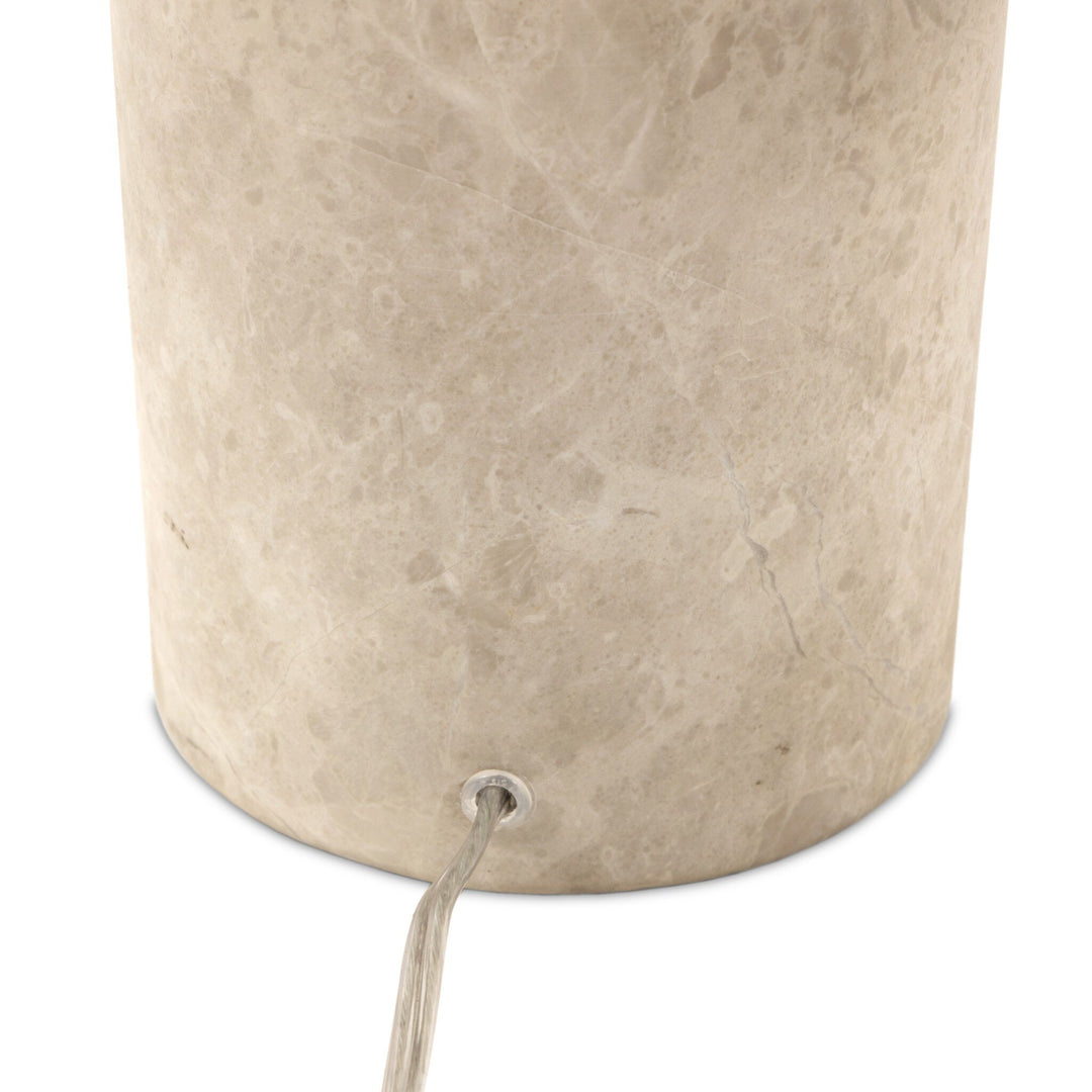 Beige cylindrical container with a string attached on a white background