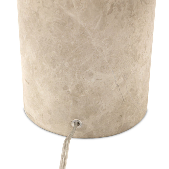 Beige cylindrical container with a string attached on a white background