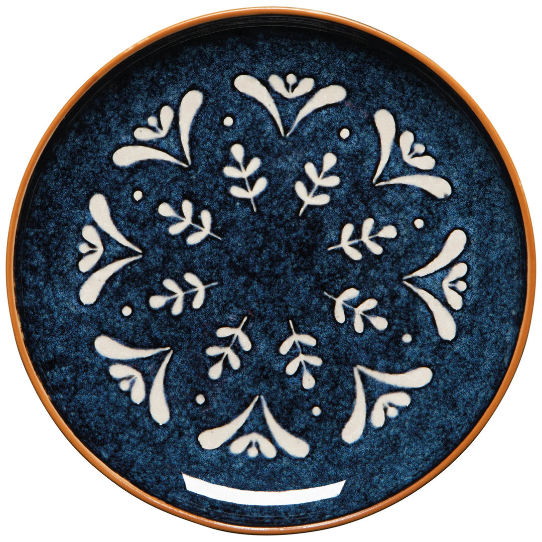 Decorative plate with white floral patterns on a blue background