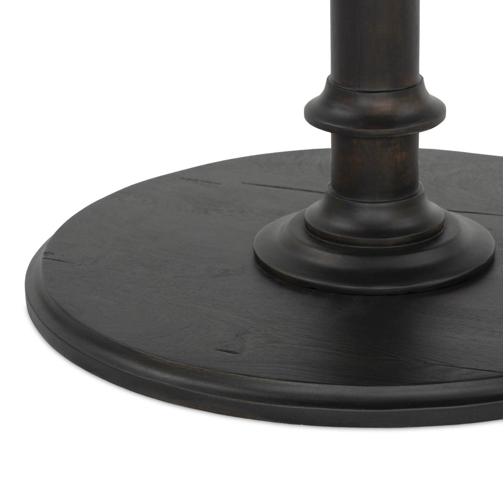 Close-up of a black metal pedestal base on a white background