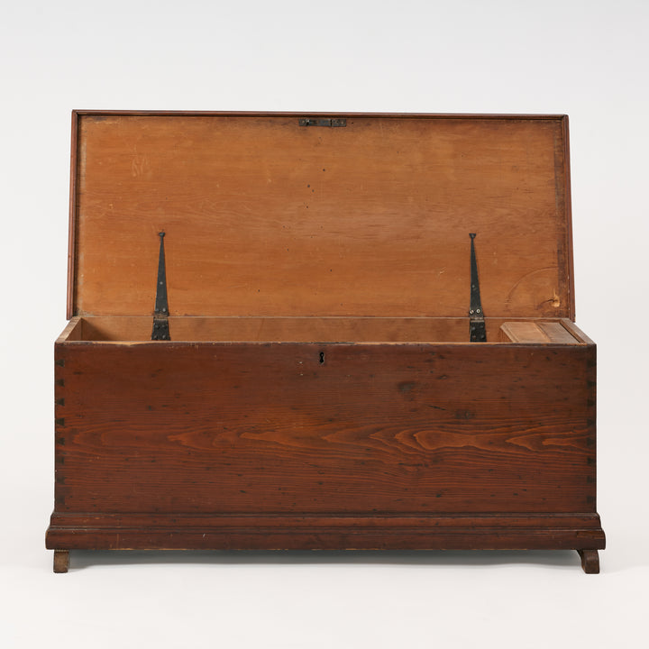 Wooden trunk with a hinged lid on a white background