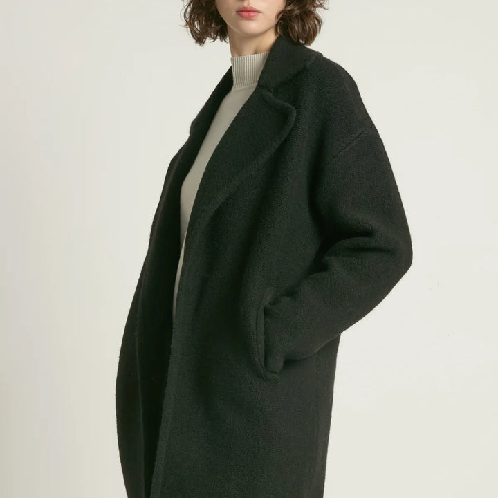 black worn by a person on a light gray background