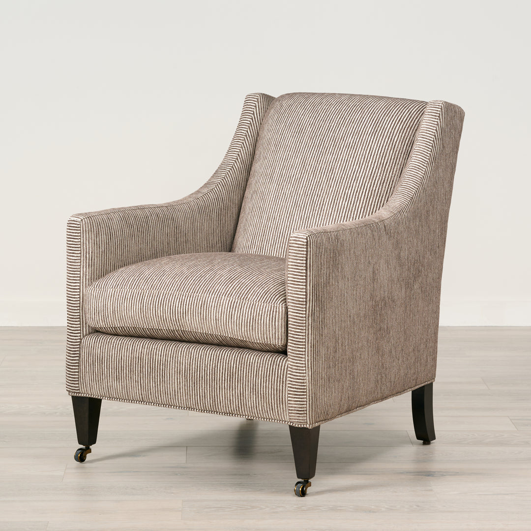 Patterned armchair on a wooden floor with a light background