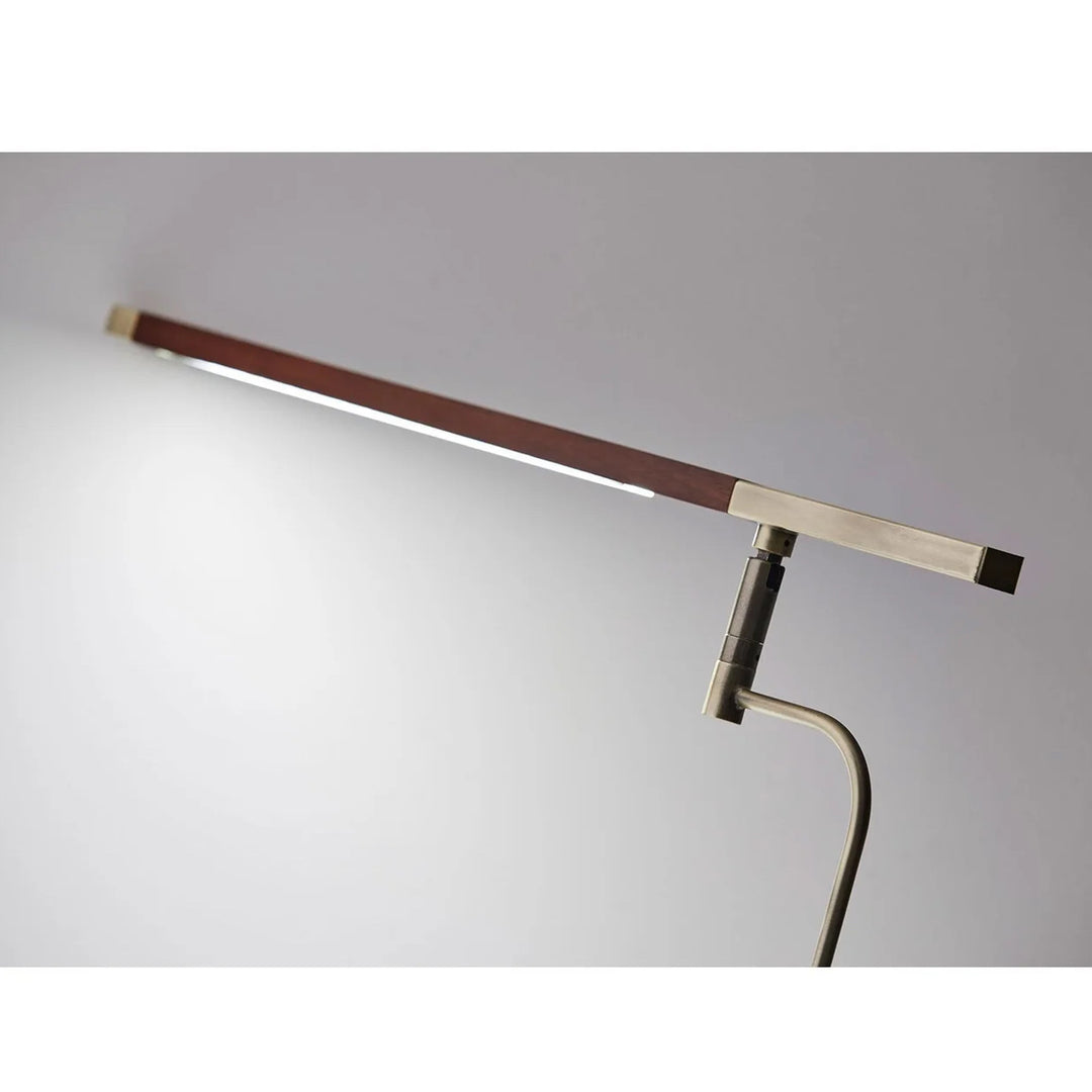 Modern floor lamp with adjustable arm on a gray background