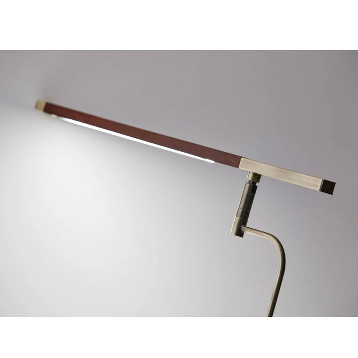 Modern floor lamp with adjustable arm on a gray background