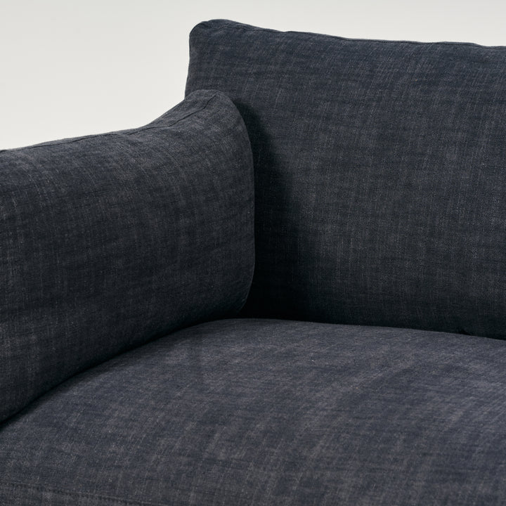 Close-up of a dark gray sofa with textured fabric on a white background