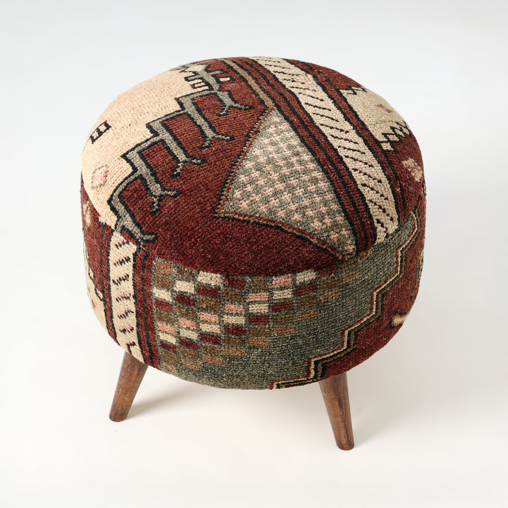 Round ottoman with patterned fabric cover on a white background