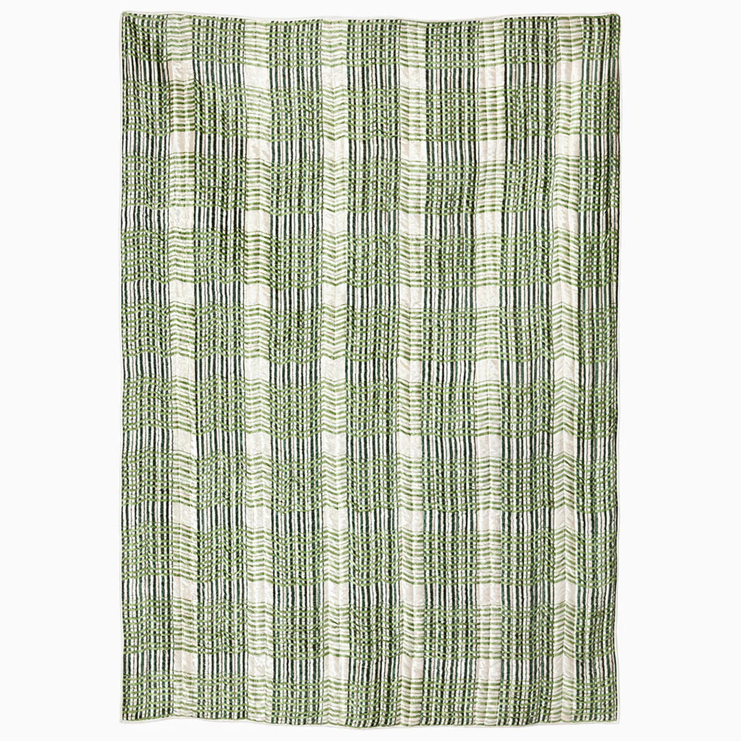 Textile with green and black striped pattern blanket on a white background