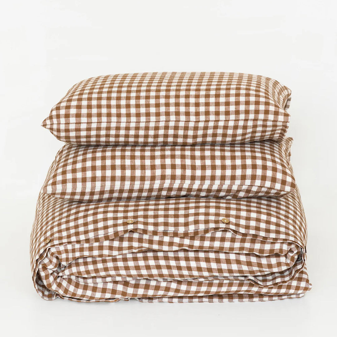 Folded brown and white checkered duvet cover on a light gray background