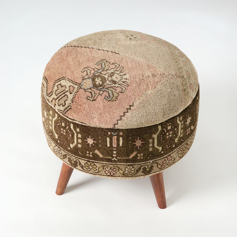 Round ottoman with intricate patterns on a white background