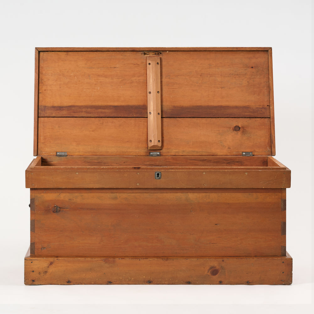 Wooden trunk with a hinged lid on a white background