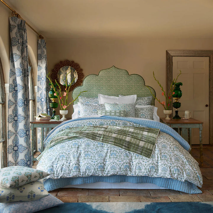 Decorative bedroom with patterned bedding and furniture