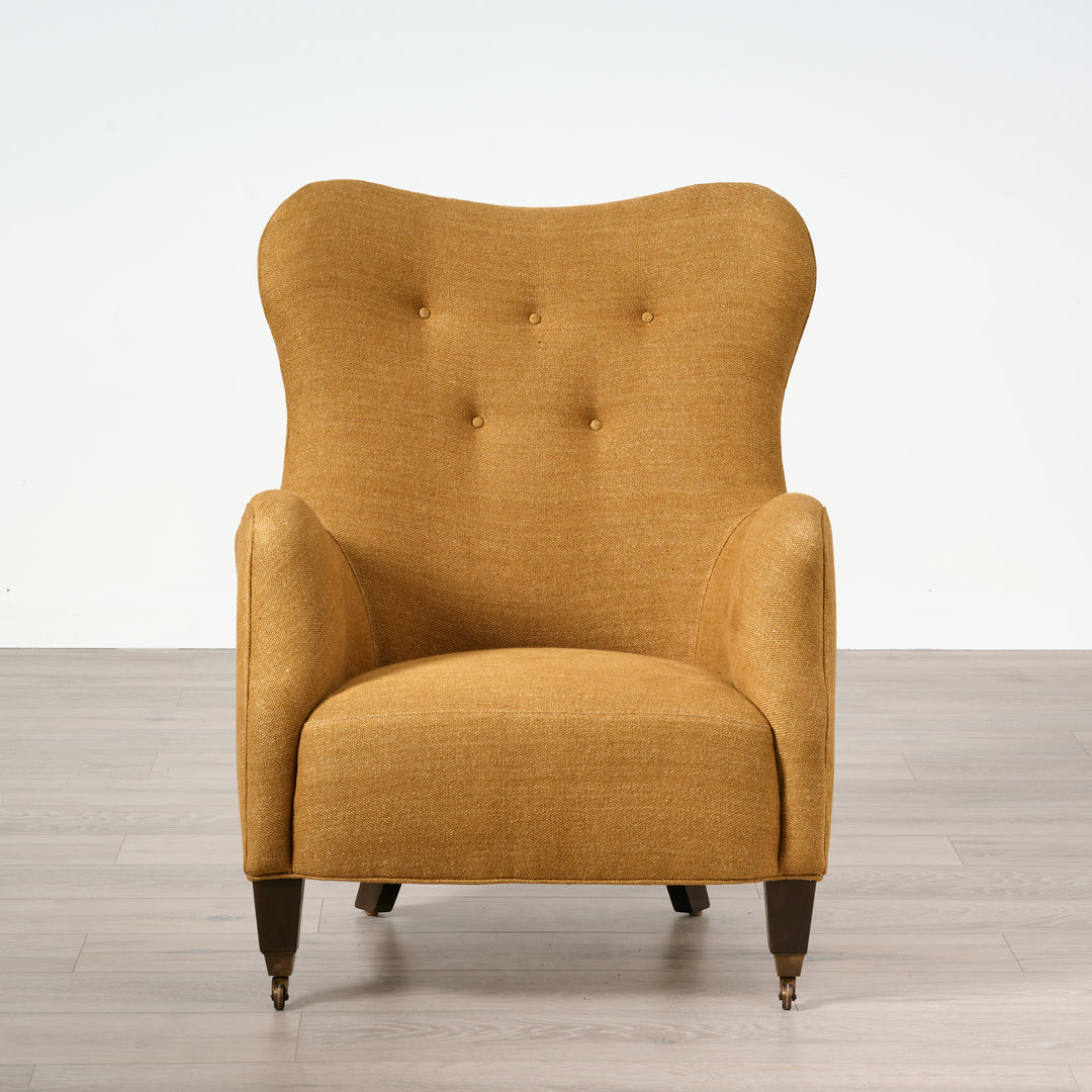 Yellow armchair on a wooden floor with a white background