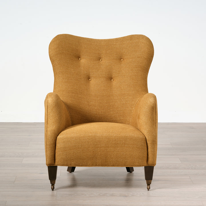 Yellow armchair on a wooden floor with a white background