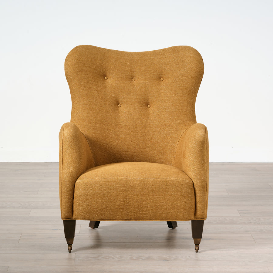 Yellow armchair on a wooden floor with a white background