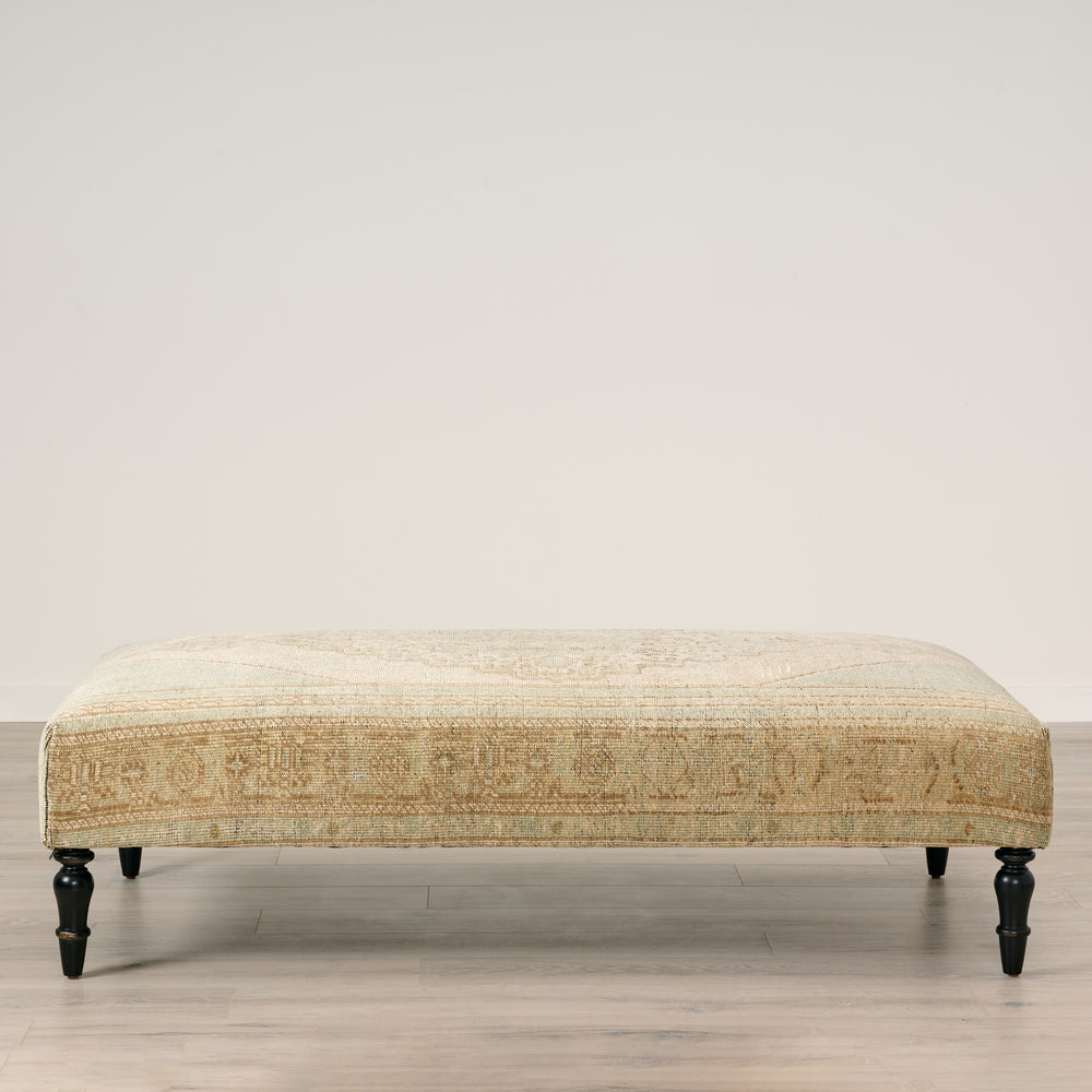 Patterned bench on a wooden floor with a neutral background