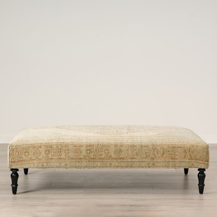 Patterned bench on a wooden floor with a neutral background