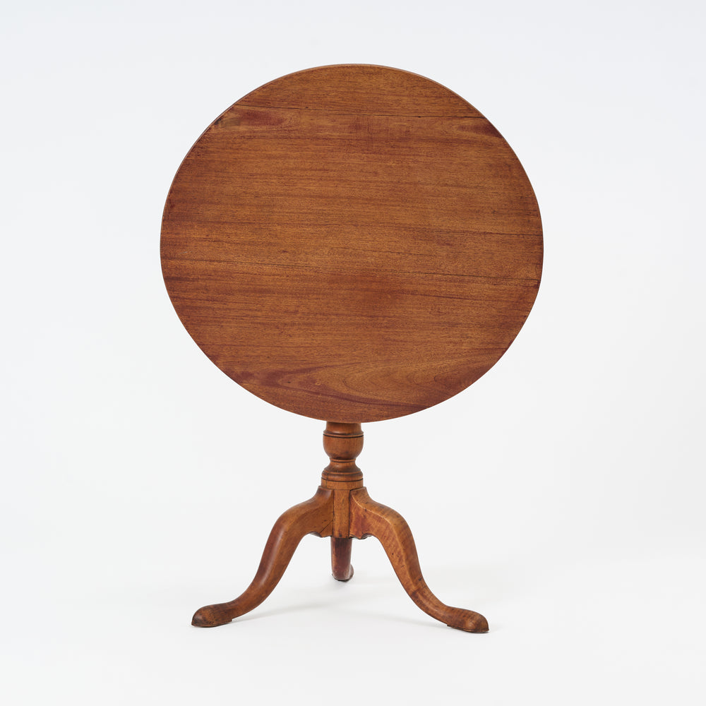 Wooden round table with a pedestal base on a white background