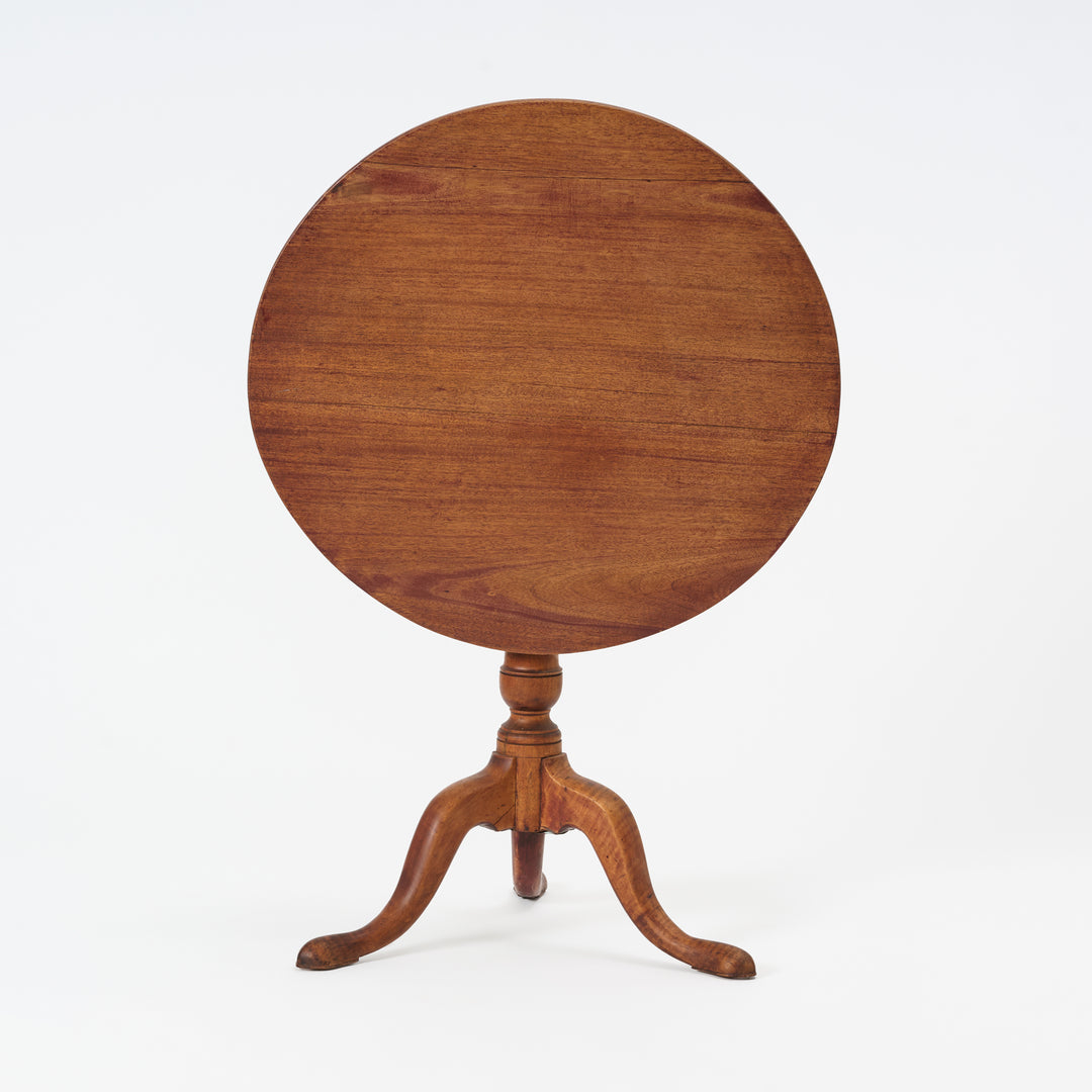 Wooden round table with a pedestal base on a white background