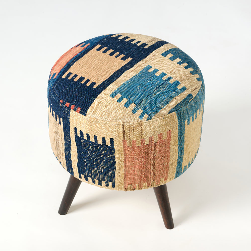 Round ottoman with geometric pattern on a white background