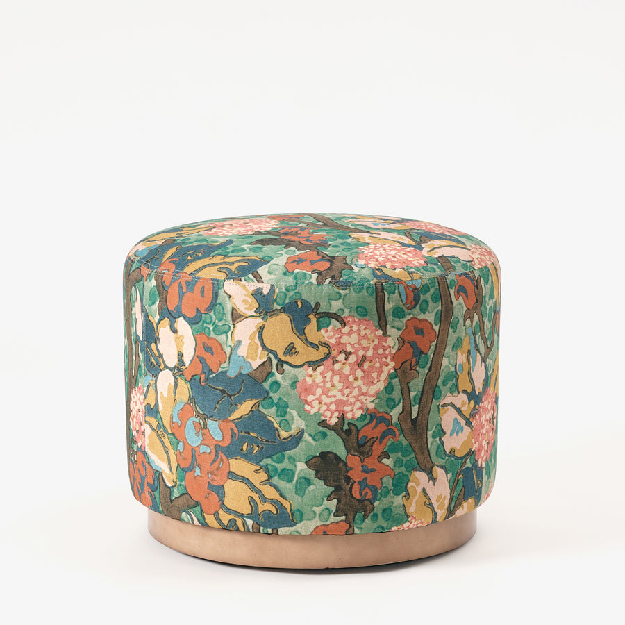 Floral patterned ottoman on a white background