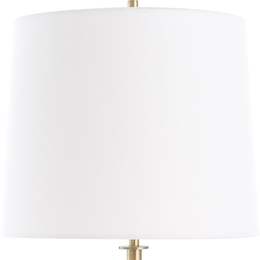 White lampshade with gold base on a white background