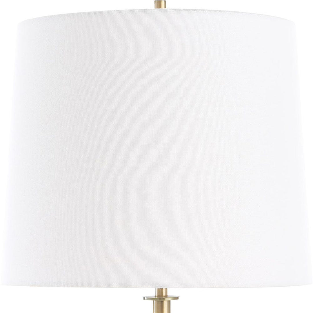 White lampshade with gold base on a white background