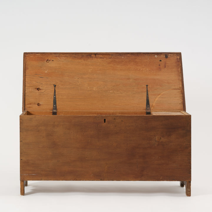 Wooden trunk with a hinged lid on a white background