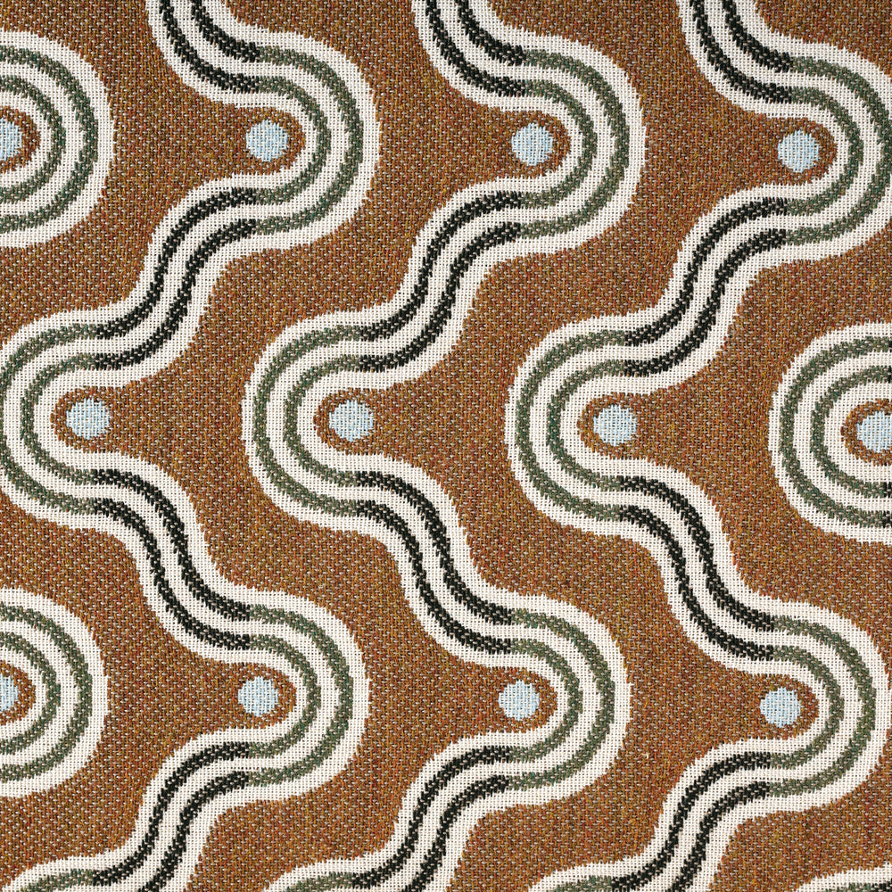 Patterned fabric with wavy lines and circular elements on a brown background