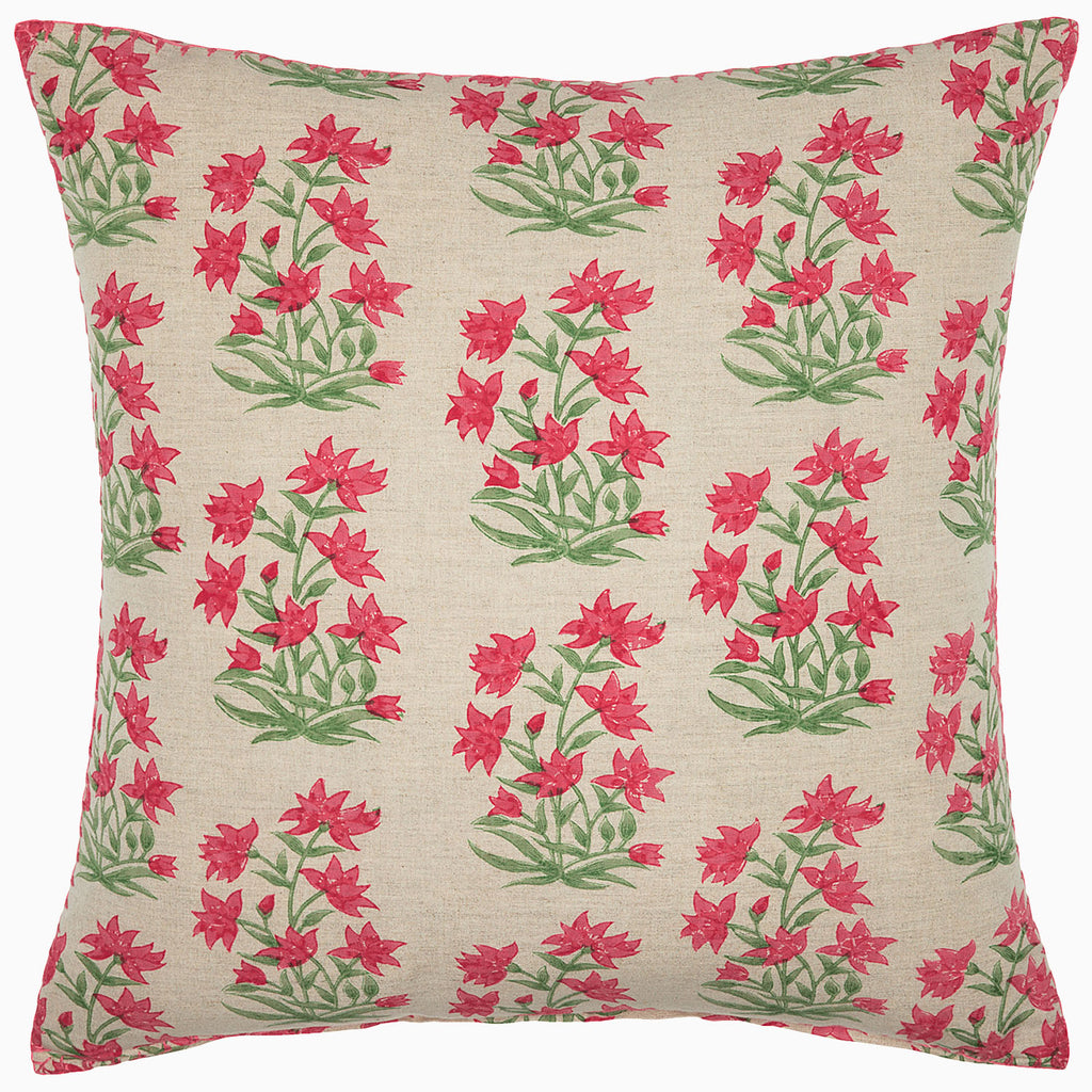 Decorative pillow with pink and green floral pattern on beige background