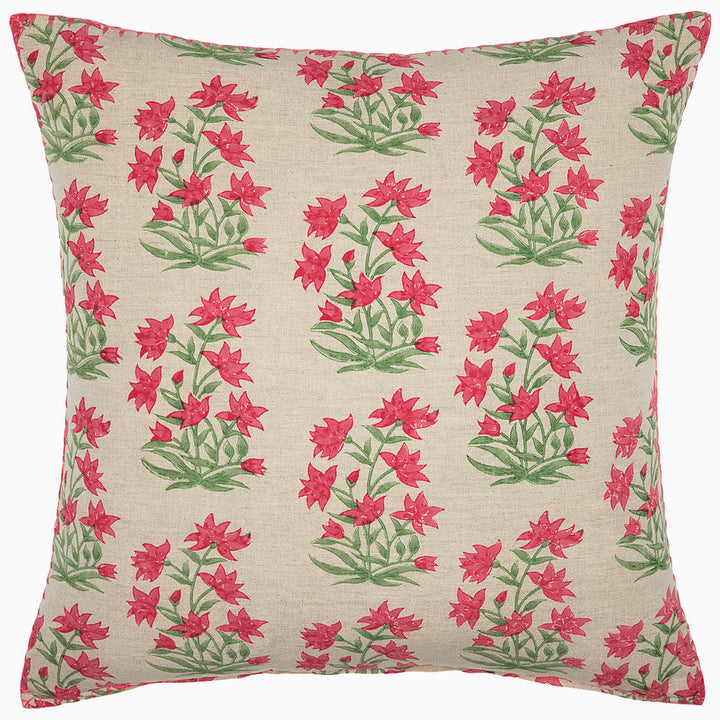 Decorative pillow with pink and green floral pattern on beige background