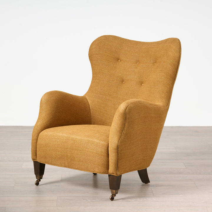 Yellow armchair on a wooden floor with a white background