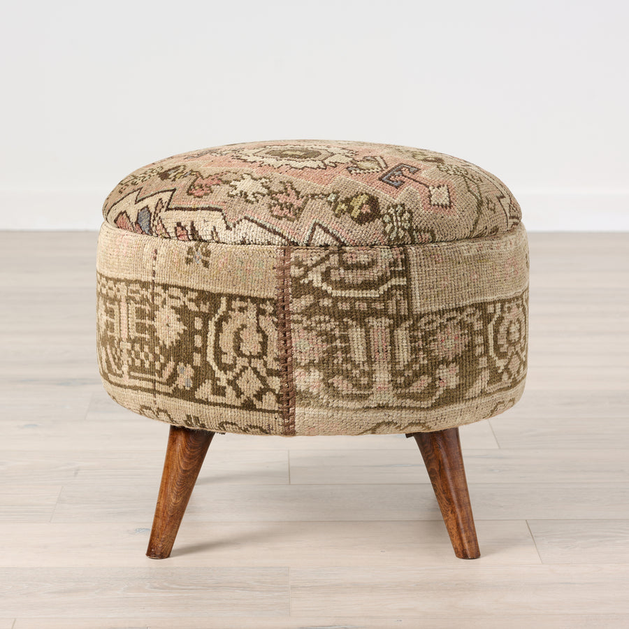Patchwork ottoman with wooden legs on a light wooden floor. Vintage Rug Medium Ottoman 0735-K.