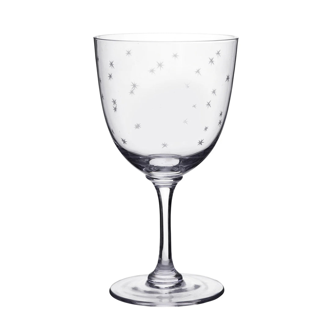 Clear glass wine glass with star patterns on a white background