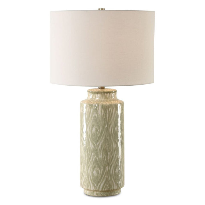 Decorative table lamp with textured ceramic base and white shade on a white background