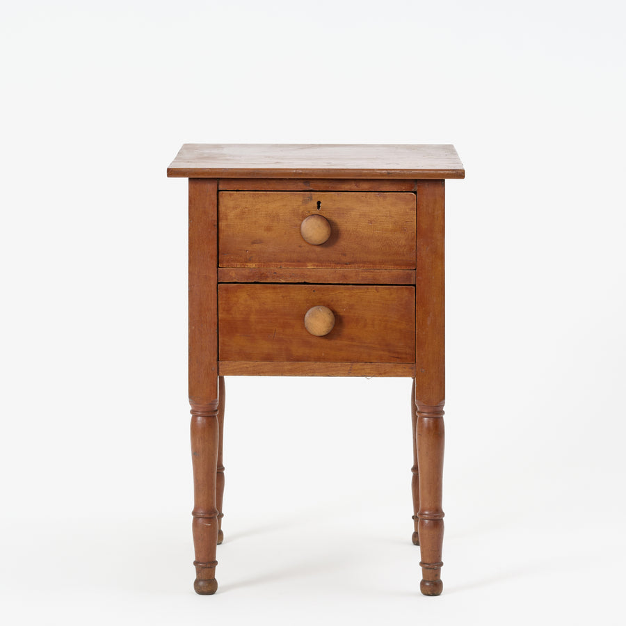 Wooden nightstand with two drawers on a white background