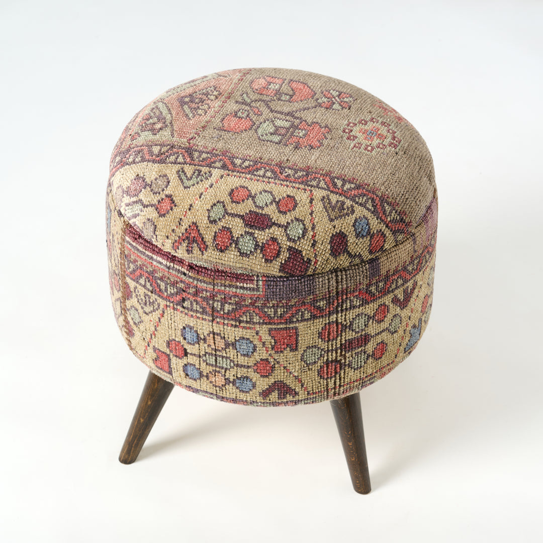 Round ottoman with patterned fabric cover on a white background.Vintage Rug Small Ottoman 0725-A