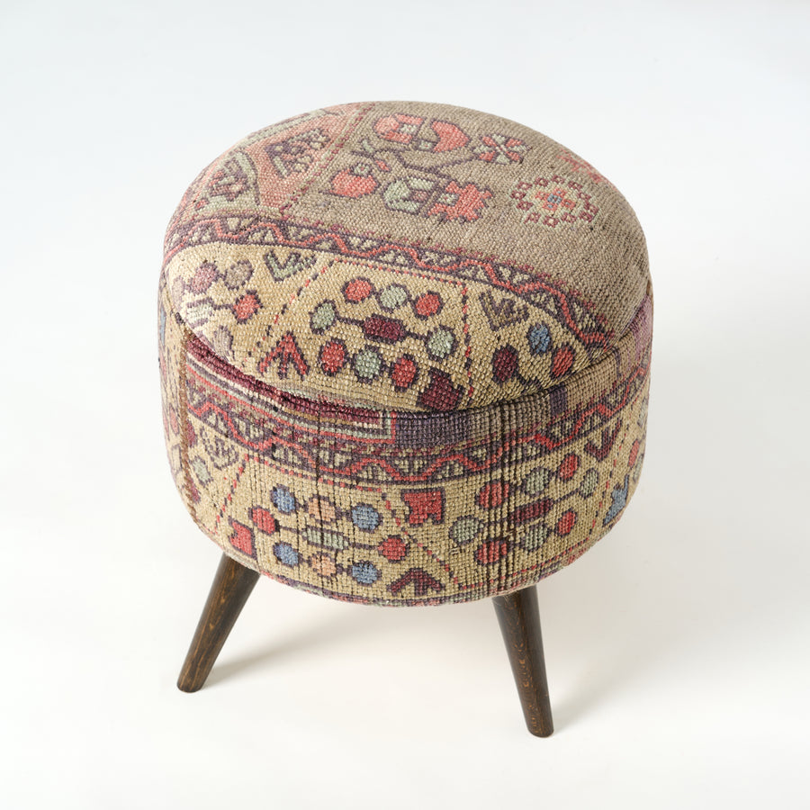 Round ottoman with patterned fabric cover on a white background.Vintage Rug Small Ottoman 0725-A