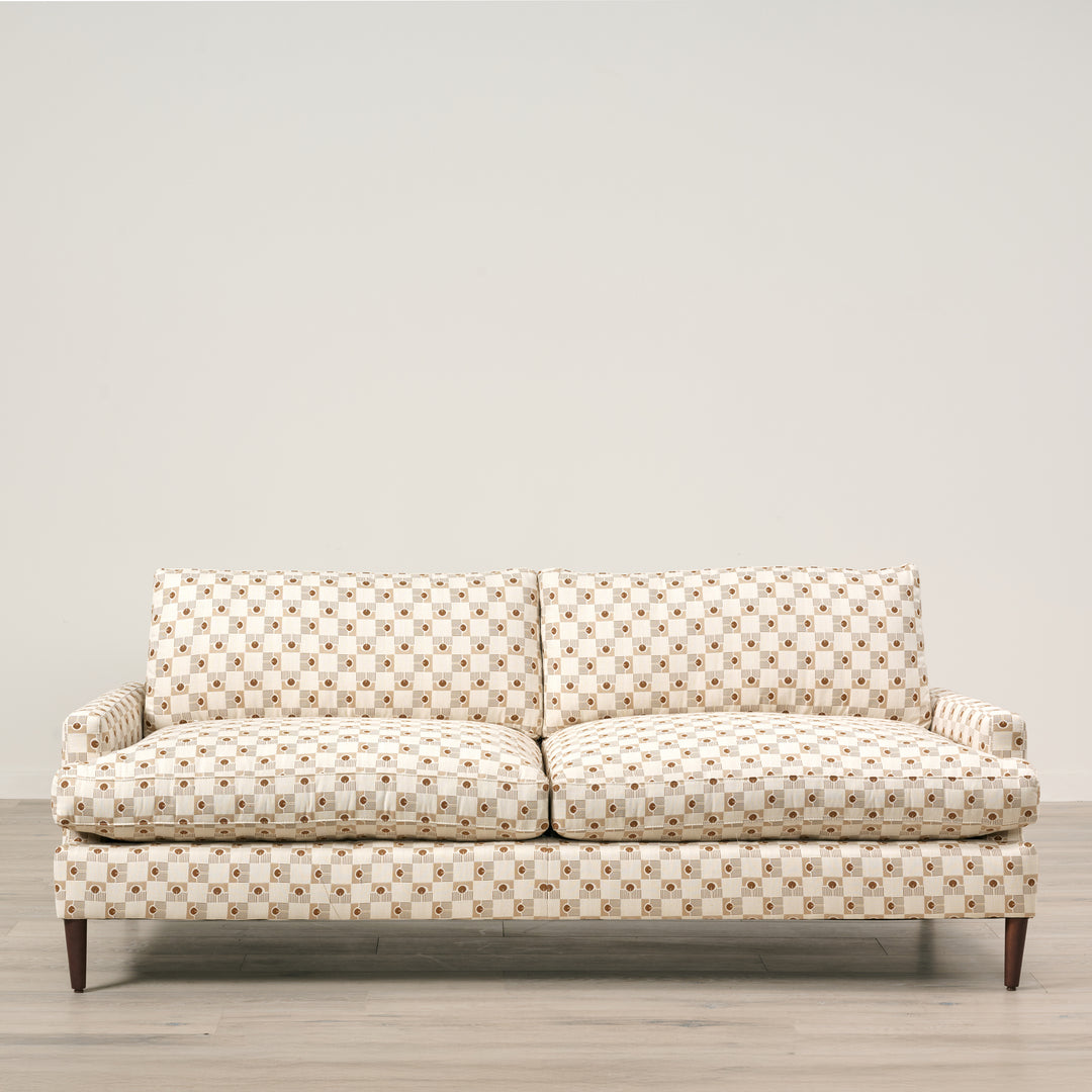 Patterned sofa on a wooden floor with a neutral background