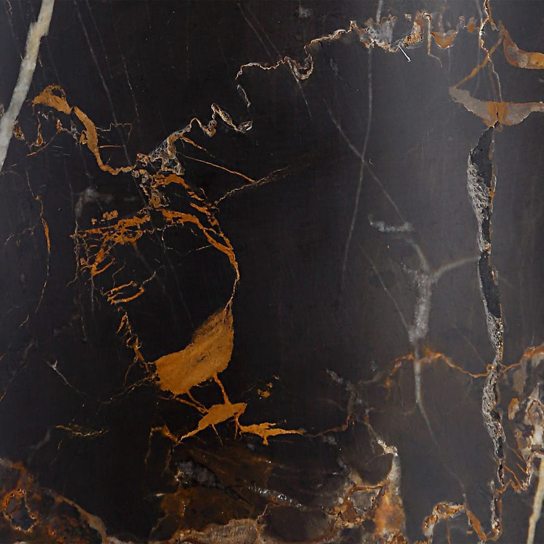 Close-up of a dark marble surface with gold and white veins