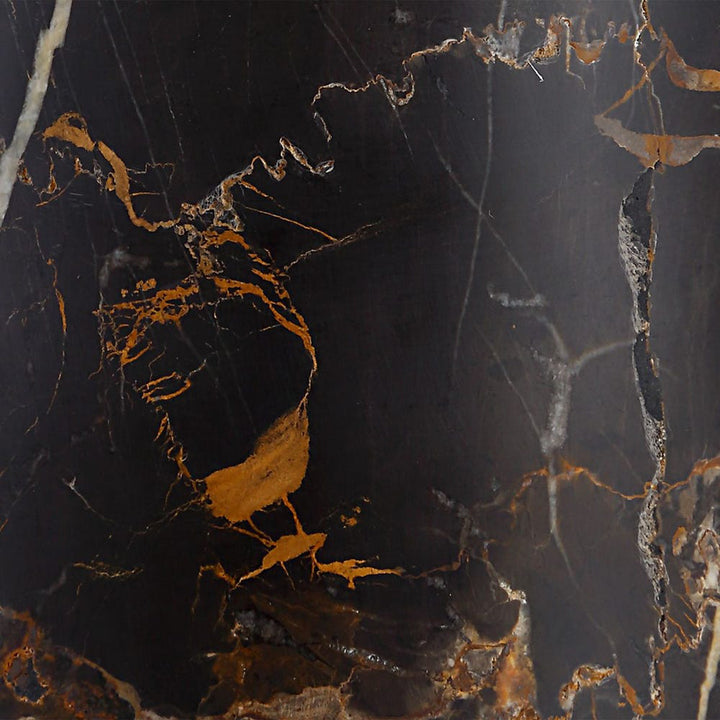 Close-up of a dark marble surface with gold and white veins