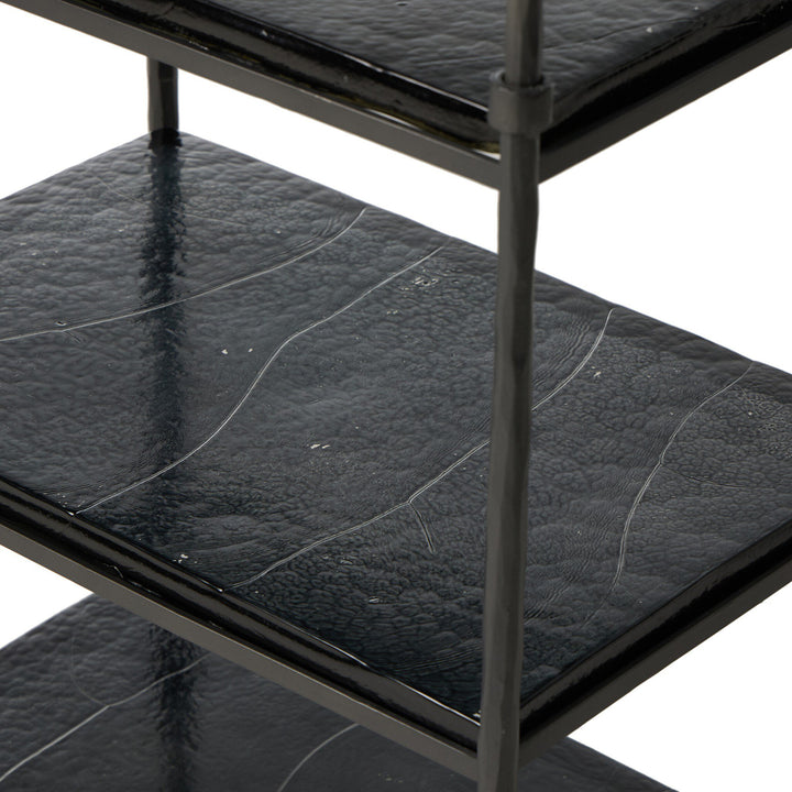 Black metal shelf with textured black glass shelves on a white background