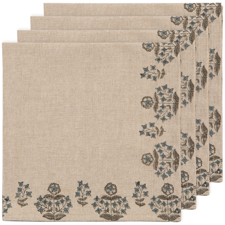 Set of four beige placemats with floral border design on a white background
