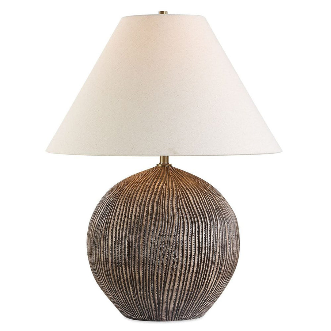 Table lamp with textured base and white shade on a white background