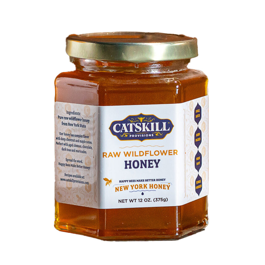 Jar of Catskill Provisions raw wildflower honey on a white background