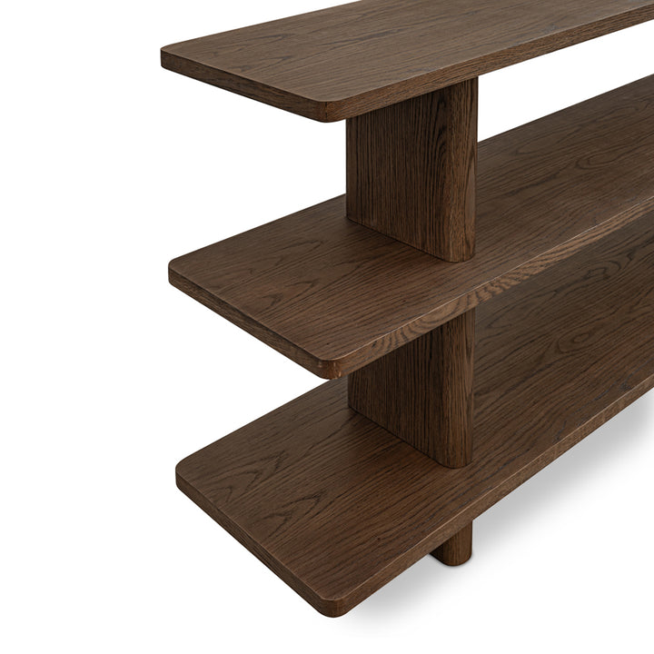 Wooden shelf with three tiers on a white background