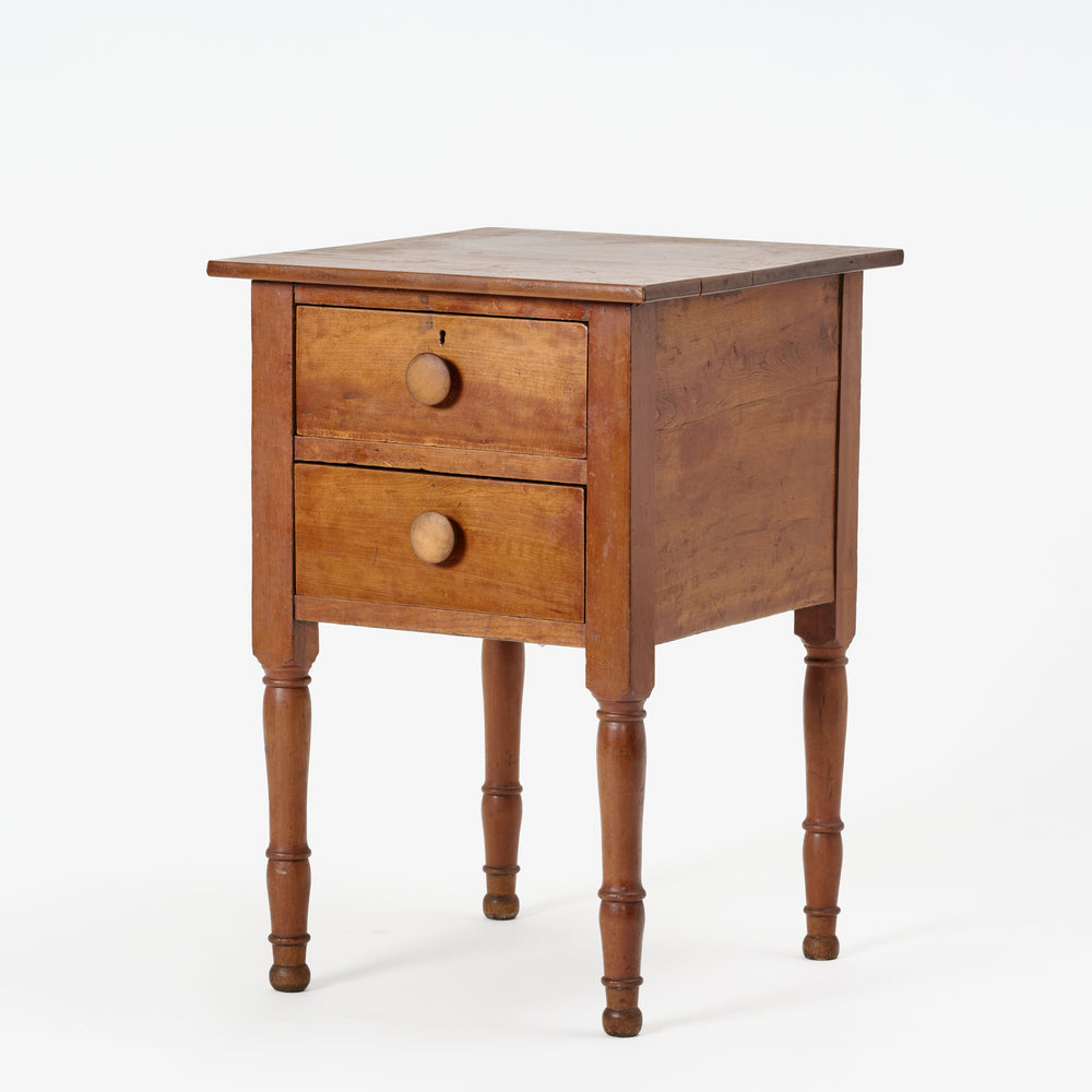 Wooden nightstand with two drawers on a white background