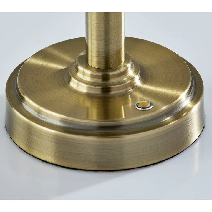 Brass base of a lamp or similar fixture on a white background