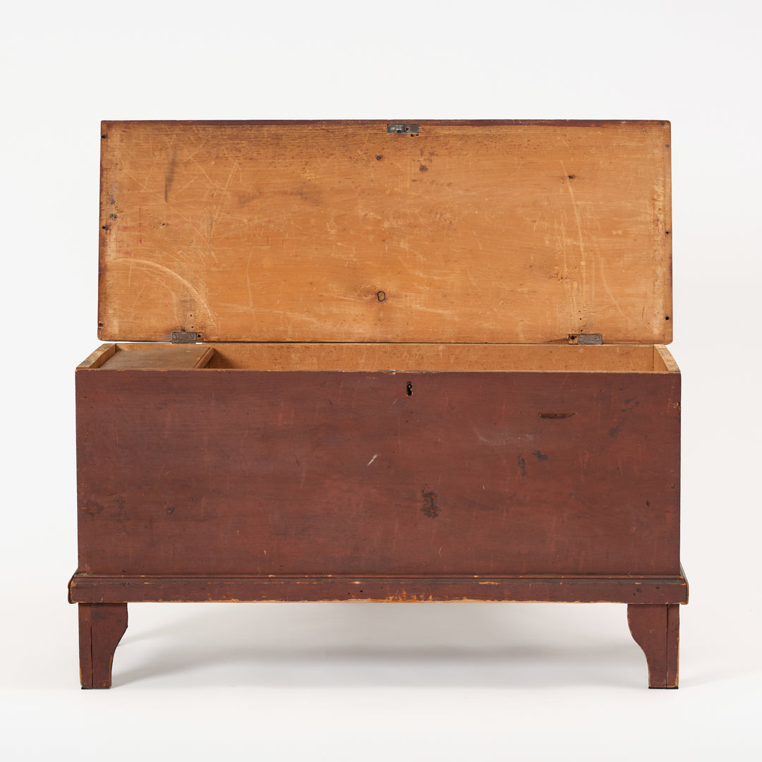 Wooden chest with a hinged lid on a white background